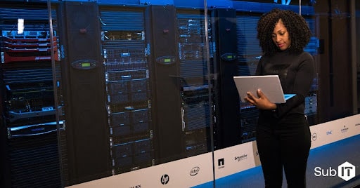 woman using laptop inside a data center