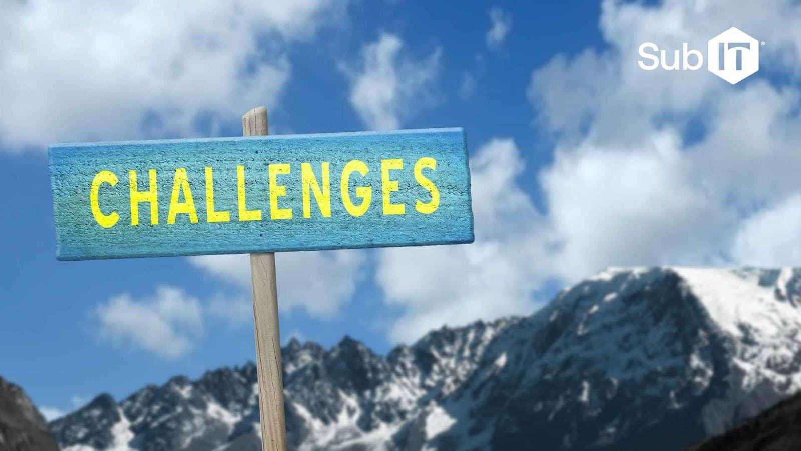 Challenges sign with mountains in background