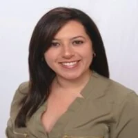 Smiling woman with dark hair in green shirt