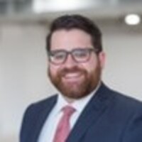 Smiling man in suit and tie indoors
