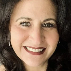 Smiling woman with dark hair and red lipstick