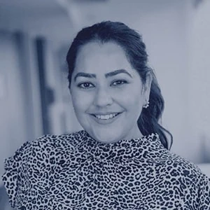 Smiling woman in leopard print top indoors