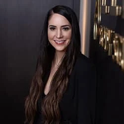 Smiling woman with long dark hair in black outfit