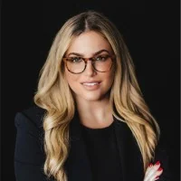 Professional woman with glasses and long blonde hair