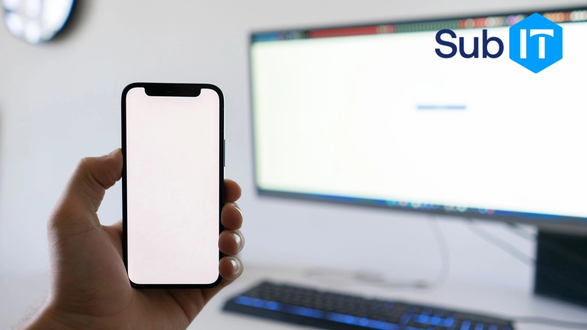Person holding smartphone near computer monitor to perform multi factor authentification