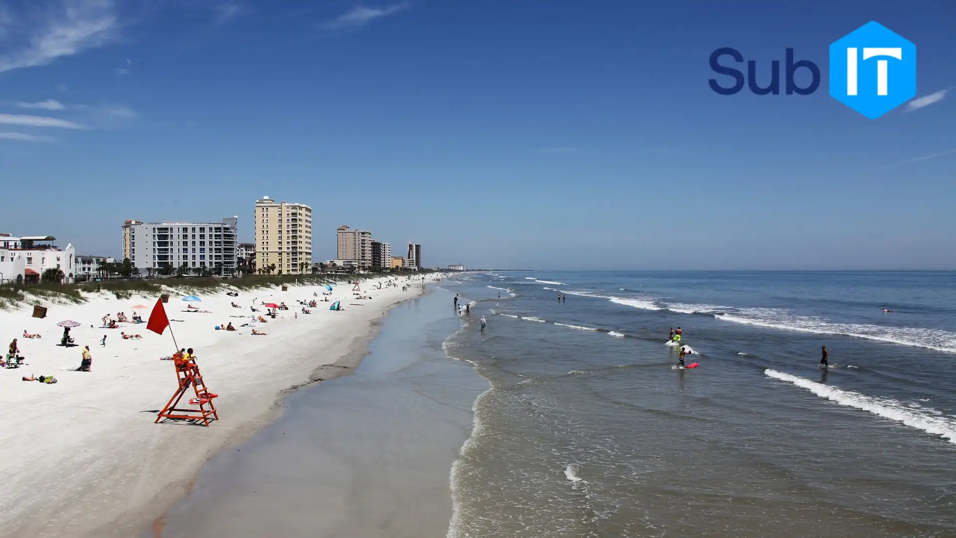 Sunny beach with lifeguard chair and condos