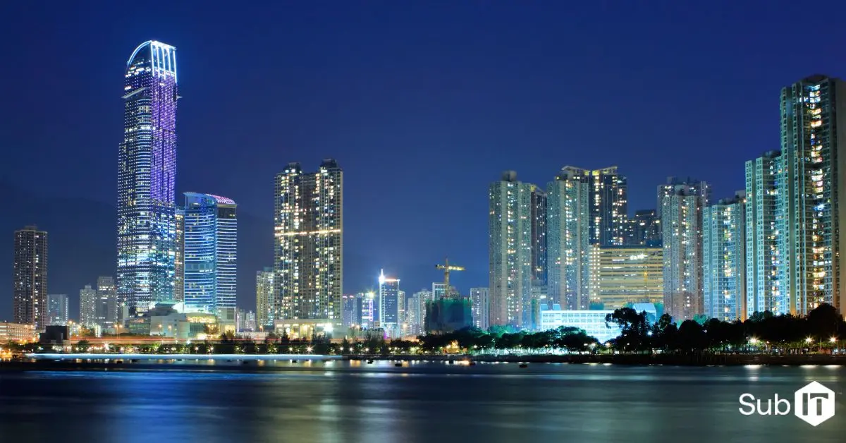 Illuminated city skyline reflected on calm waterfront