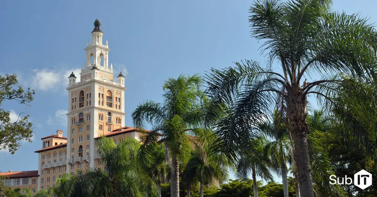 Mediterranean-style tower framed by palm trees in coral gables, florida